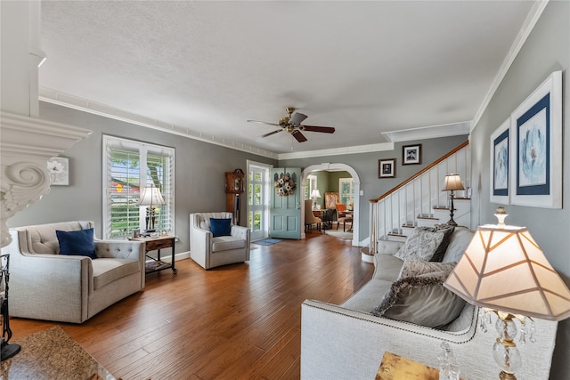 living room with hardwood / wood-style floors, ceiling fan, crown molding, and a textured ceiling