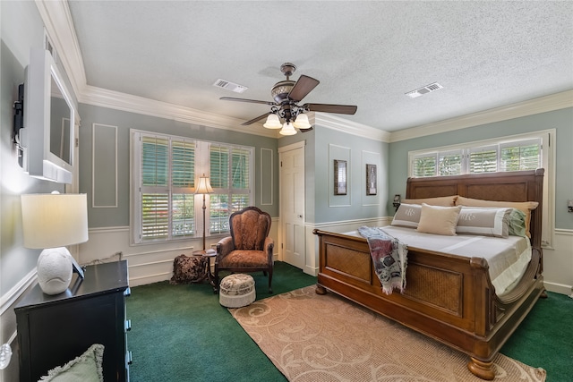 carpeted bedroom featuring a closet, ceiling fan, crown molding, and a textured ceiling