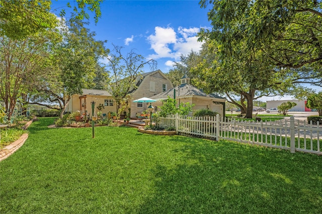 view of yard with a garage and a fenced front yard