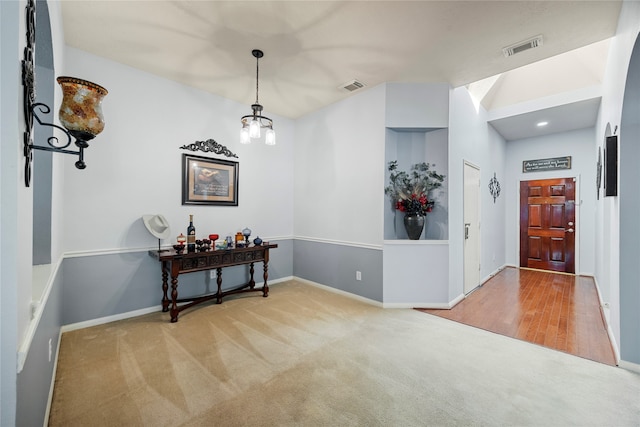 interior space featuring an inviting chandelier and light hardwood / wood-style floors