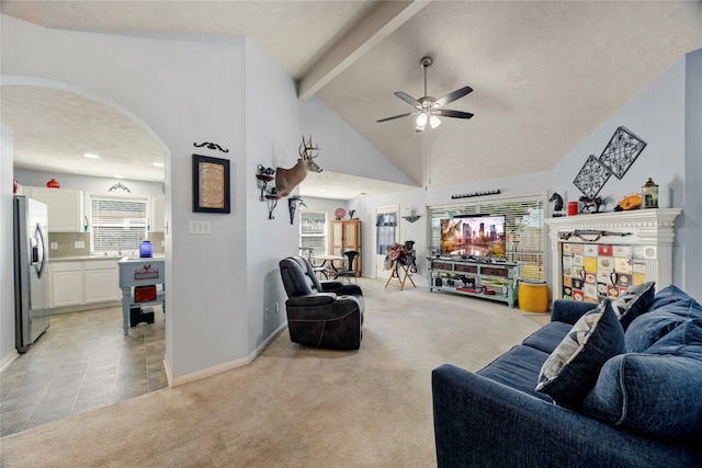 living room with ceiling fan, a textured ceiling, light carpet, and high vaulted ceiling