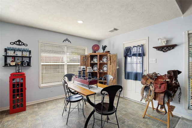 dining room featuring a textured ceiling