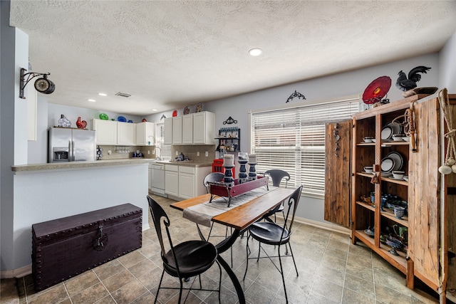 dining area with a textured ceiling and sink