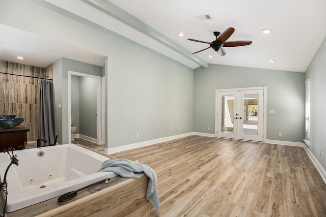 bathroom with lofted ceiling, french doors, ceiling fan, toilet, and wood-type flooring