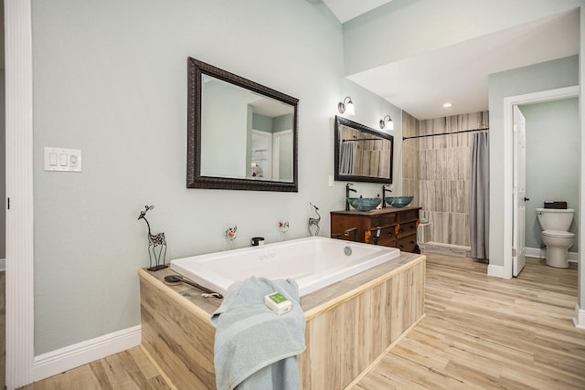 bathroom featuring a bathtub, wood-type flooring, and toilet