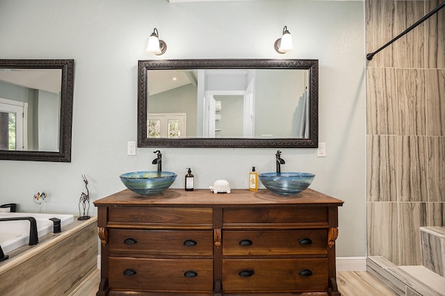 bathroom featuring vanity, vaulted ceiling, and hardwood / wood-style flooring