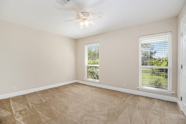 empty room featuring light carpet and ceiling fan