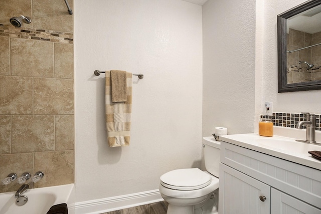 full bathroom with vanity, wood-type flooring, tiled shower / bath combo, and toilet