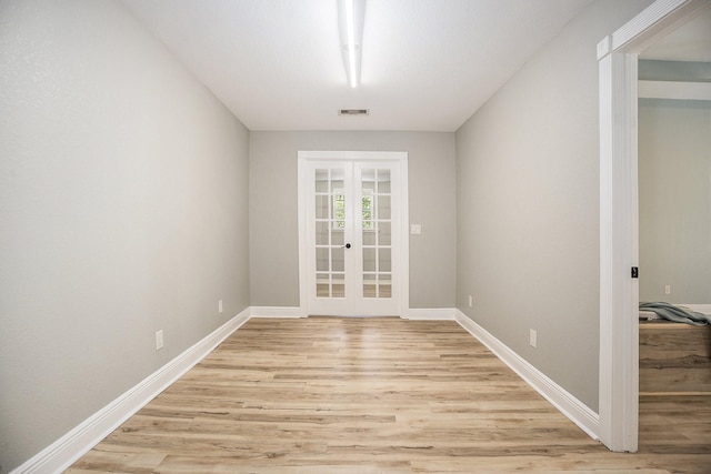 interior space with french doors and light hardwood / wood-style flooring