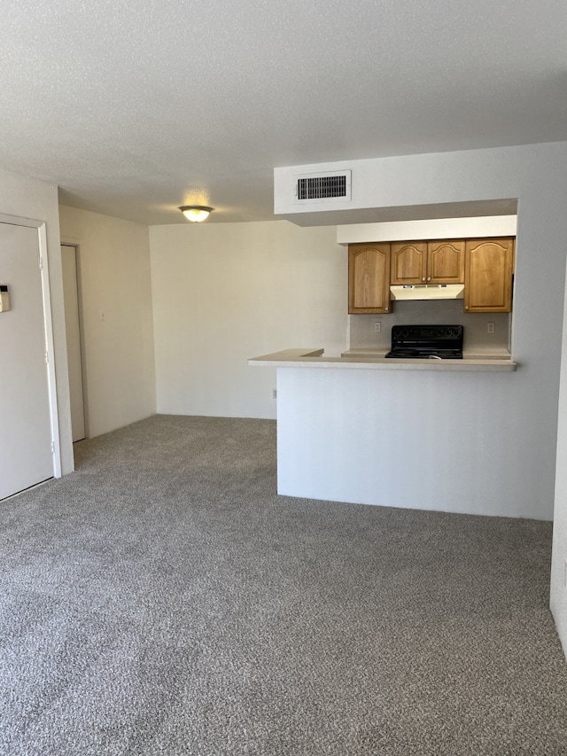 kitchen featuring a textured ceiling, carpet floors, kitchen peninsula, and black stove