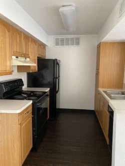 kitchen featuring black range with electric cooktop and dark hardwood / wood-style floors