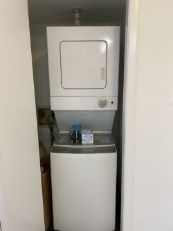 laundry area with stacked washer / dryer