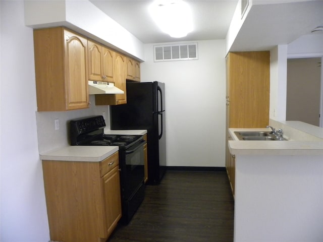 kitchen featuring kitchen peninsula, dark wood-type flooring, black appliances, and sink