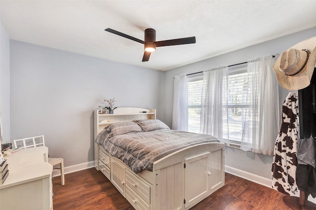 bedroom with dark hardwood / wood-style floors and ceiling fan