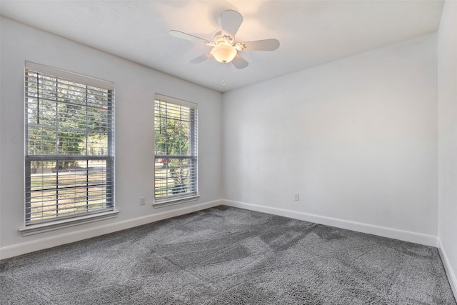 carpeted spare room with ceiling fan and a healthy amount of sunlight