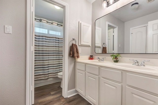 bathroom with vanity, toilet, wood-type flooring, and a shower with shower curtain