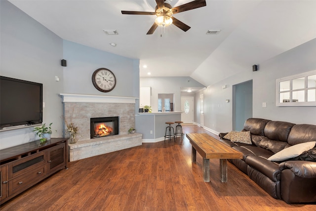 living room featuring wood-type flooring, a fireplace, plenty of natural light, ceiling fan, and vaulted ceiling