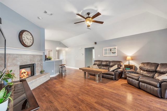 living room featuring lofted ceiling, hardwood / wood-style floors, and ceiling fan