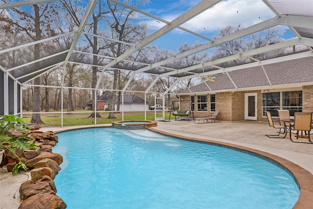 view of pool featuring an in ground hot tub, a patio, and glass enclosure