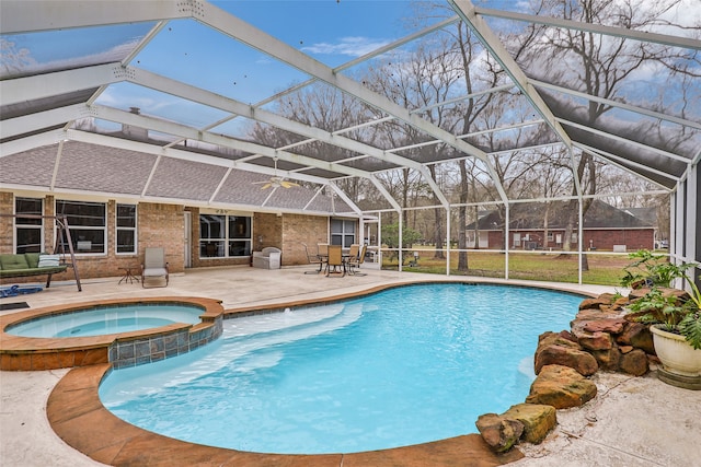 view of pool featuring a patio, an in ground hot tub, and glass enclosure