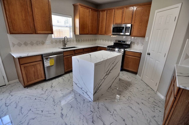 kitchen with tasteful backsplash, appliances with stainless steel finishes, light stone countertops, sink, and a center island