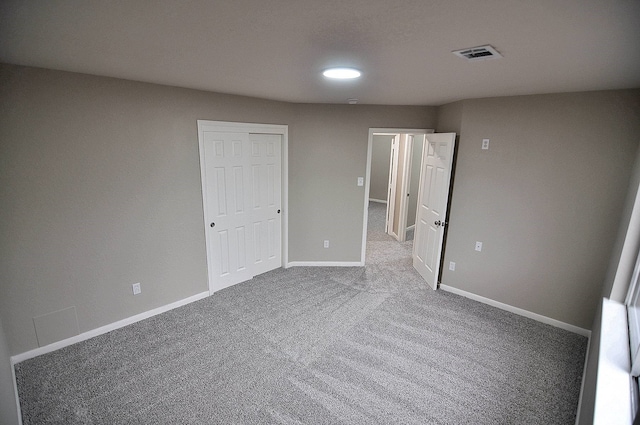 unfurnished bedroom with carpet and a closet