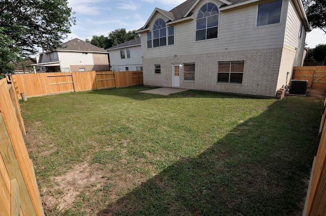 rear view of house with a patio, a lawn, and cooling unit