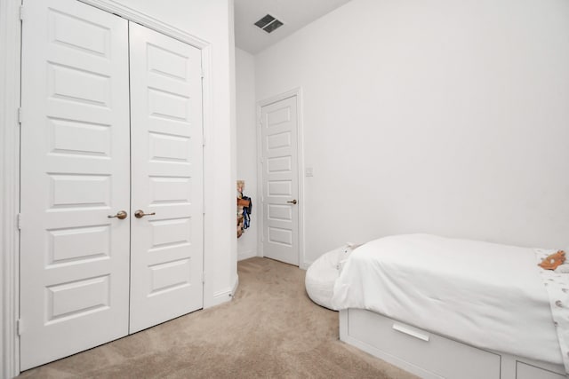 carpeted bedroom featuring a closet