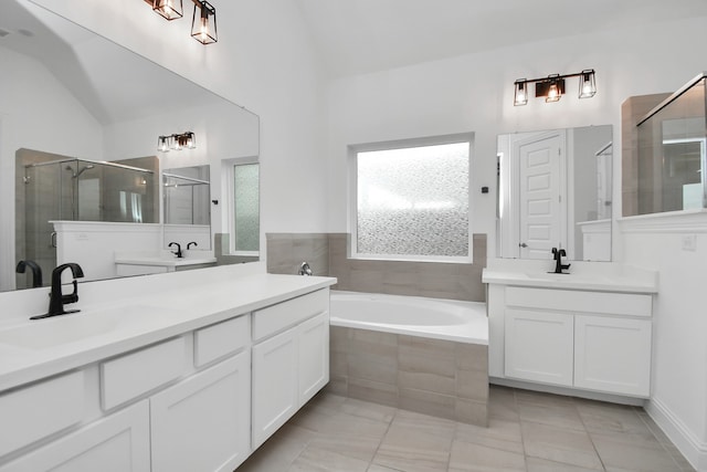 bathroom with vanity, plus walk in shower, lofted ceiling, and tile patterned flooring