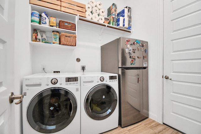 washroom with independent washer and dryer and light hardwood / wood-style flooring