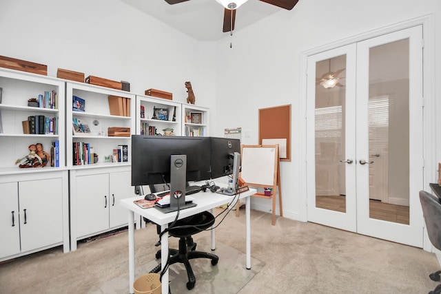 carpeted office space featuring french doors and ceiling fan