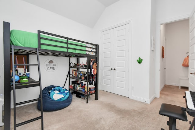 bedroom with lofted ceiling, light carpet, and a closet