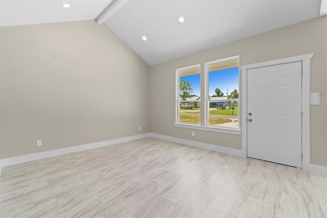 unfurnished room with lofted ceiling with beams