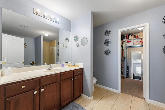 bathroom featuring vanity, toilet, and tile patterned floors