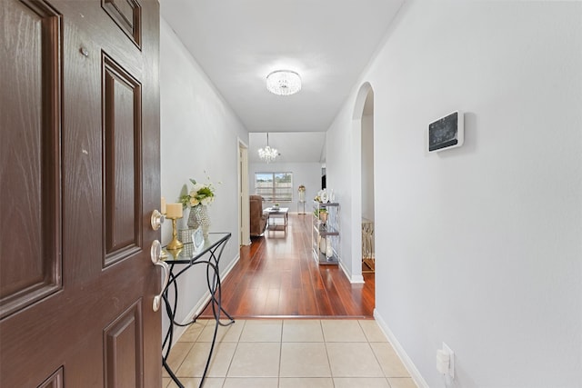 interior space with light hardwood / wood-style floors and a notable chandelier