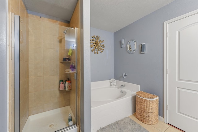 bathroom featuring tile patterned flooring, a textured ceiling, and separate shower and tub