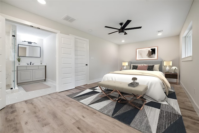 bedroom featuring connected bathroom, ceiling fan, and light hardwood / wood-style floors