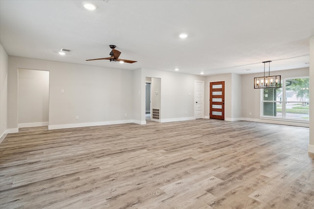 unfurnished living room with light hardwood / wood-style floors and ceiling fan with notable chandelier