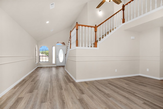 entryway with ceiling fan, light hardwood / wood-style flooring, and high vaulted ceiling