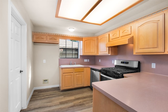 kitchen with sink, stainless steel appliances, light brown cabinetry, and dark wood-type flooring