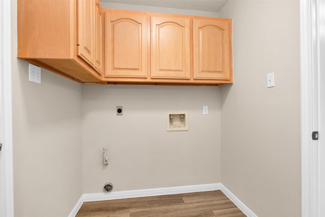 clothes washing area with hookup for a washing machine, dark hardwood / wood-style flooring, cabinets, and hookup for an electric dryer