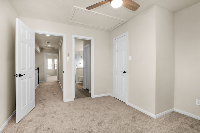 unfurnished bedroom with ceiling fan and light colored carpet