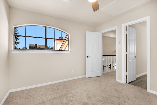 unfurnished bedroom with ceiling fan and carpet