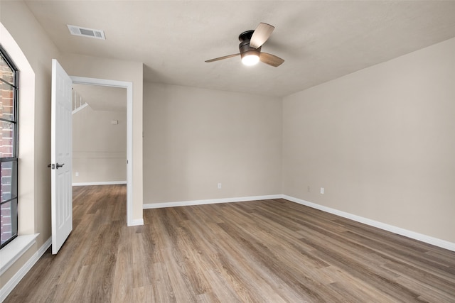 unfurnished room with light hardwood / wood-style flooring and ceiling fan