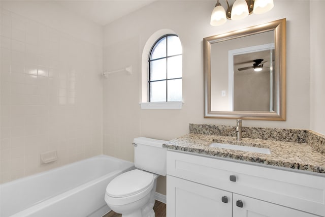 full bathroom featuring ceiling fan, wood-type flooring, toilet, vanity, and bathtub / shower combination