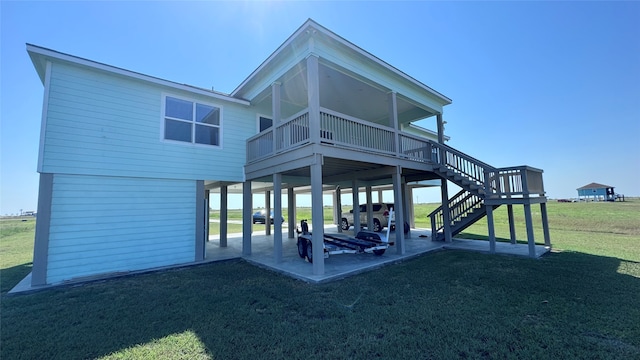 back of house with a patio and a yard