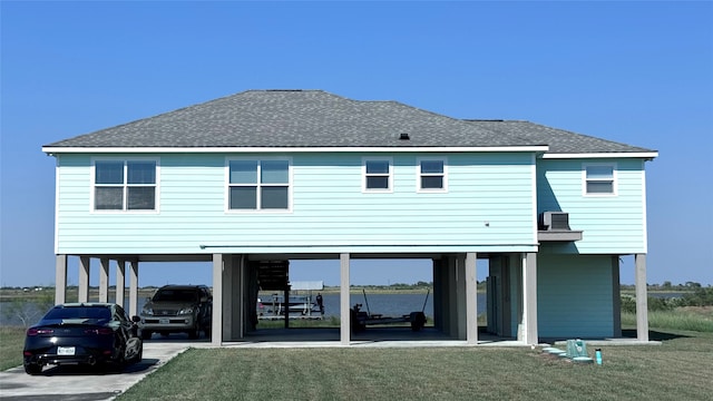 rear view of house featuring a lawn