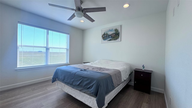 bedroom with ceiling fan and dark hardwood / wood-style floors