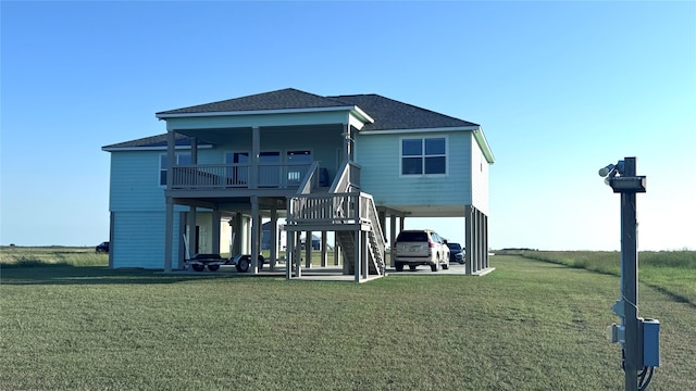 rear view of property featuring a lawn and a carport