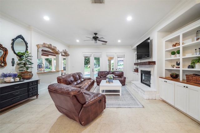 living room with french doors, crown molding, light tile patterned floors, and ceiling fan